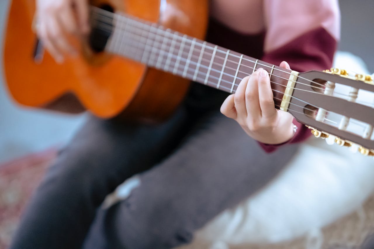 A guitar student playing one of the best classical guitars for beginners