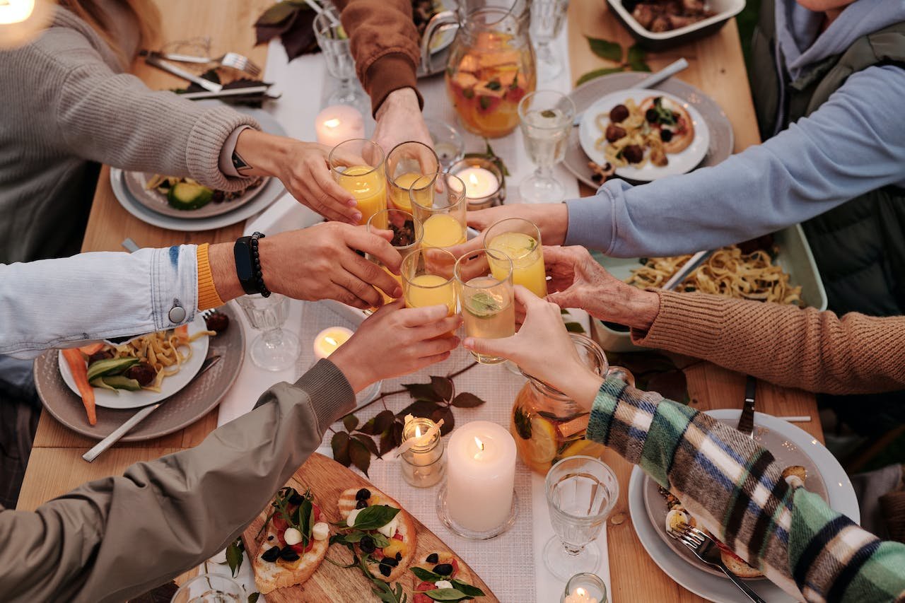 A private event with people gathered around a dinner table sharing a toast