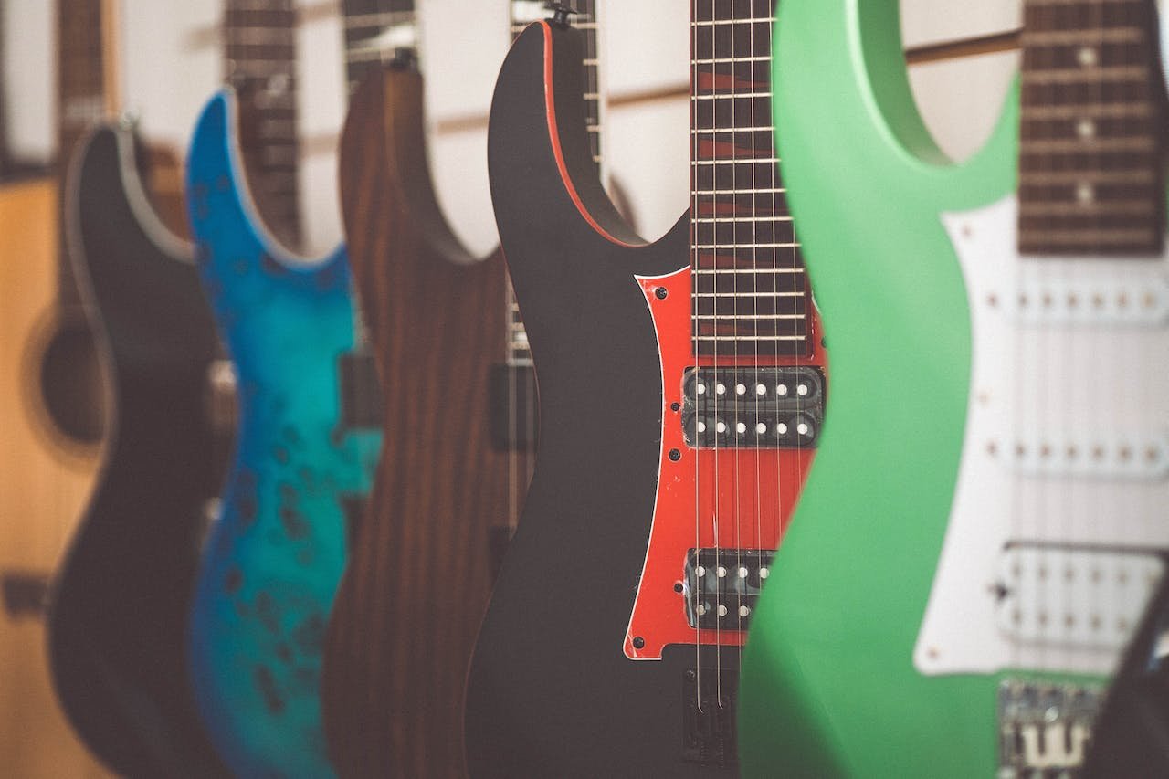 Guitar center guitars hanging on a wall
